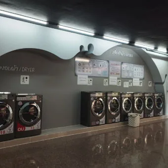 Self-service laundry corner at Herma Hotel